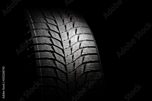 Winter high performance studless tire on black background