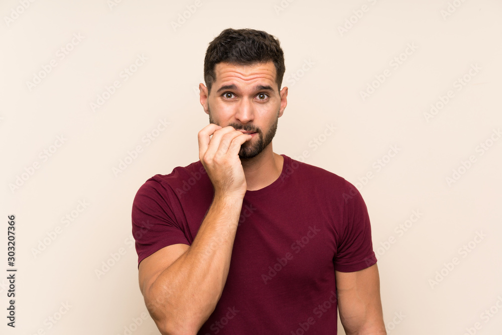 Handsome man over isolated background nervous and scared Handsome man over isolated background nervous and scared