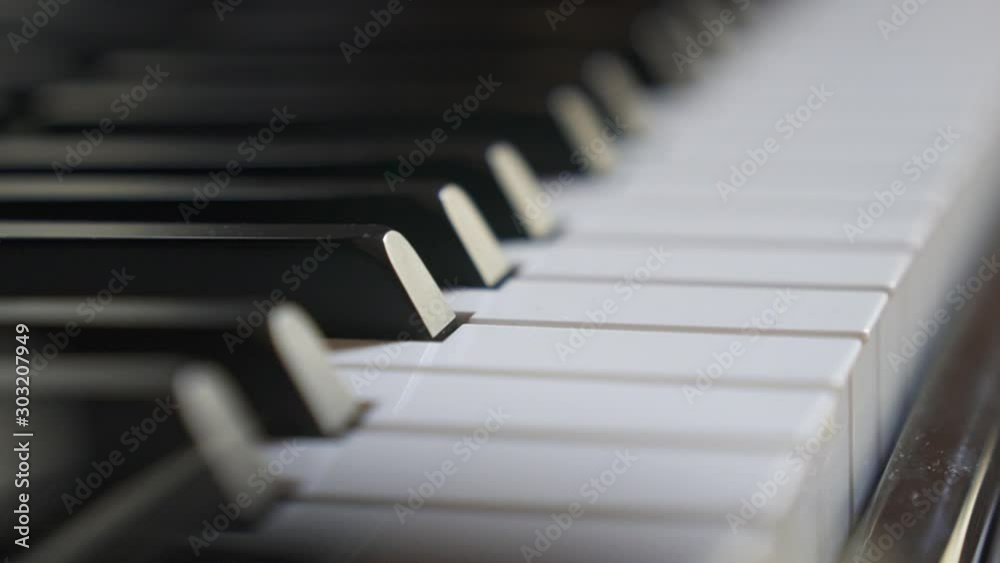 Focus shot of piano keys. camera moving along the piano keyboard slowly. piano aesthetics Focus shot of piano keys. camera moving along the piano keyboard slowly. piano aesthetics