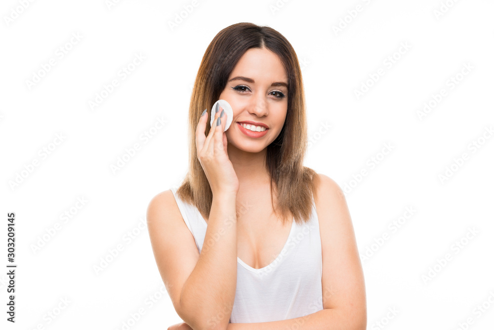 Young woman removing makeup from her face with cotton pad Young woman removing makeup from her face with cotton pad