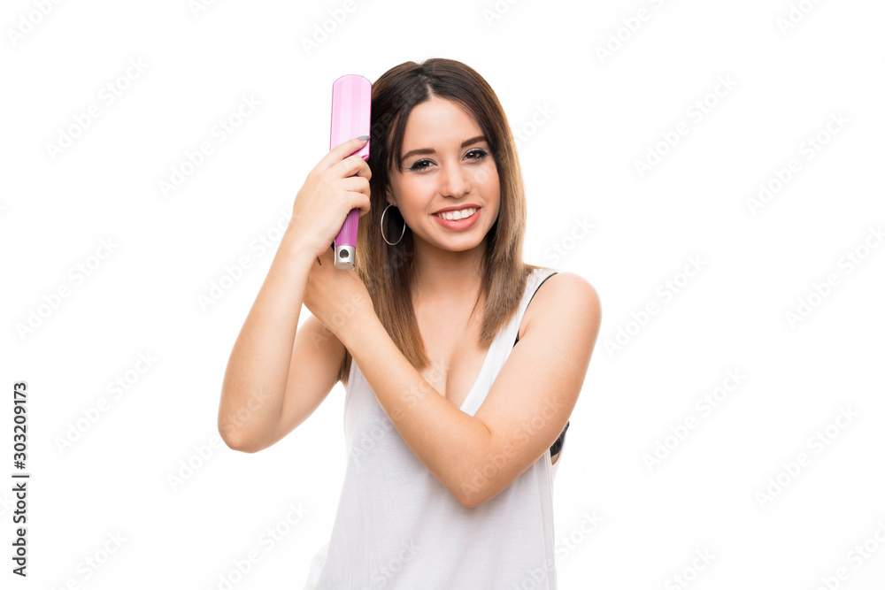 Young woman over isolated white background with hair comb Young woman over isolated white background with hair comb
