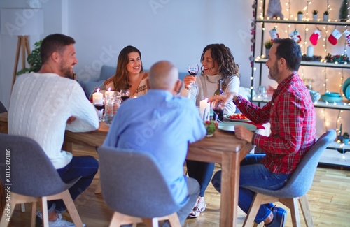 Beautiful family smiling happy and confident. Eating roasted turkey celebrating Christmas at home