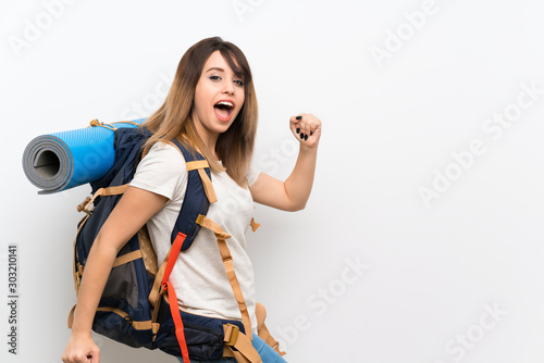 Young traveler woman over white background and walking
