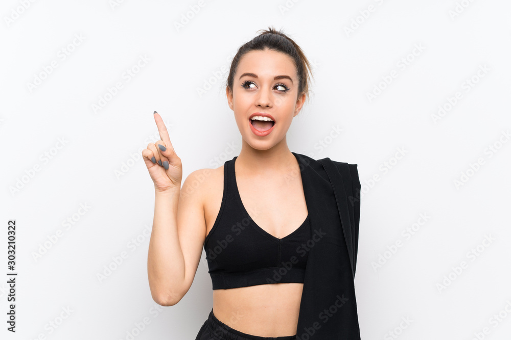Young sport woman over white wall intending to realizes the solution while lifting a finger up Young sport woman over white wall intending to realizes the solution while lifting a finger up