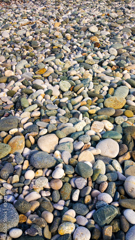 the texture of gravel with beautiful colors. ground pebble background. Beautiful background texture with sea pebbles. the texture of gravel with beautiful colors. ground pebble background. Beautiful background texture with sea pebbles.