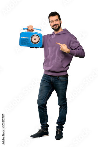 Handsome man with sweatshirt holding a radio © luismolinero