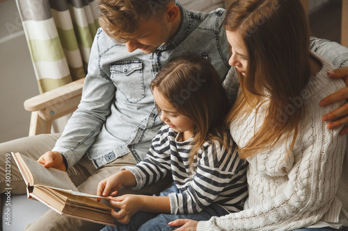 Family at home together leisure love concept reading fairy tale