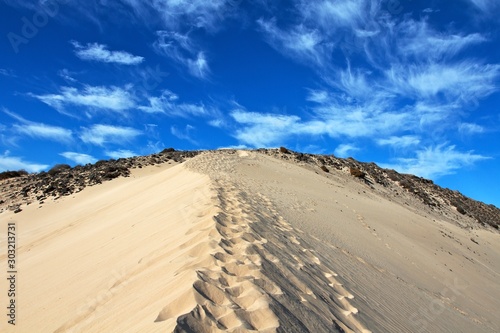 Footsteps in the sand of an high dune of a Fuerteventura beach, Canary island 