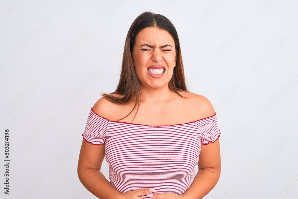 Fototapeta premium Portrait of beautiful young woman standing over isolated white background with hand on stomach because indigestion, painful illness feeling unwell. Ache concept.