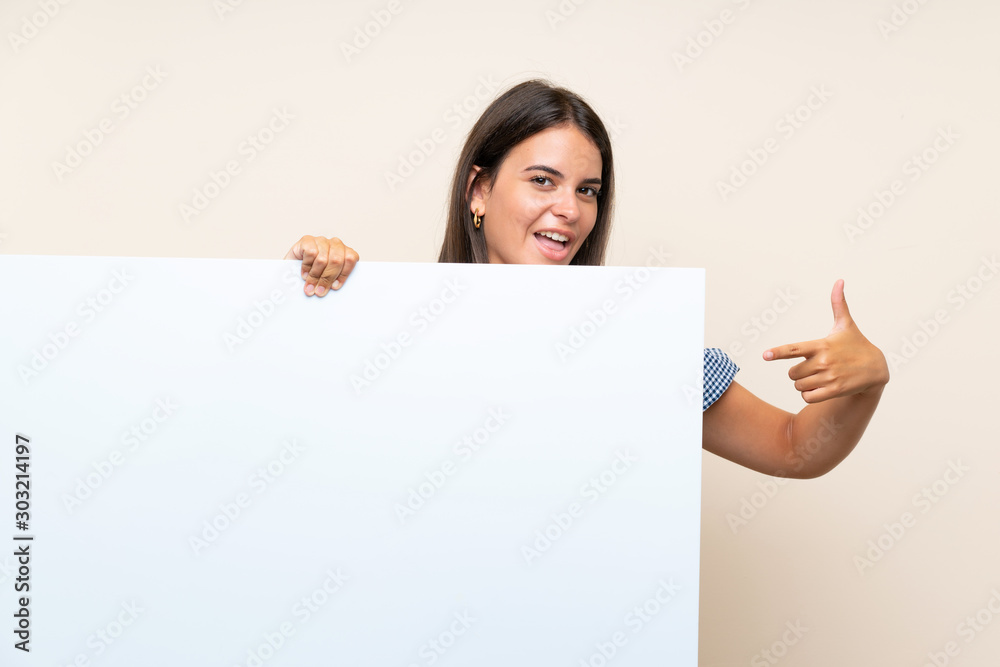 Young girl over isolated background holding an empty white placard for insert a concept Young girl over isolated background holding an empty white placard for insert a concept