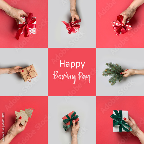 Female hands holding different gifts and Christmas tree on grey. Xmas greeting card. Happy Boxing day.
