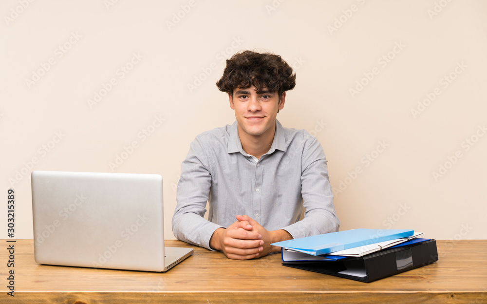 Young student man with a laptop keeping the arms crossed in frontal position Young student man with a laptop keeping the arms crossed in frontal position