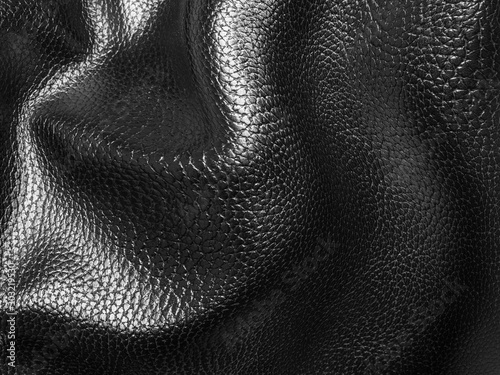 Wrinkled rough black leather background in high resolution