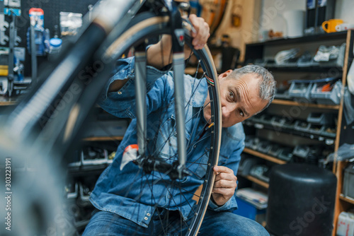 Bike mechanic repairing a wheel