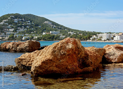 Rocks in front of the beach of Santa Eulària des Riu on the island of Ibiza