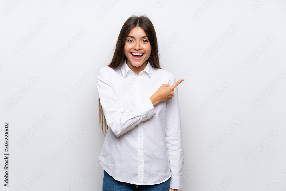 Young woman over isolated white background pointing finger to the side Young woman over isolated white background pointing finger to the side
