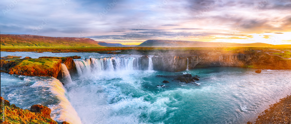 Fantastic sunrise scene of powerful Godafoss waterfall.