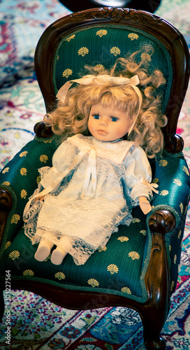 antique doll in a chair  photo