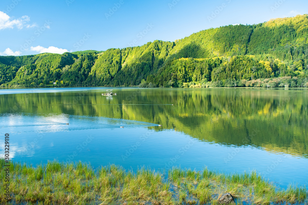 A beautiful and scenic view of Lagoa das Furnas (Furnas Lake) that fills a crater located in Furnas, São Miguel Island, Azores, Portugal. A beautiful and scenic view of Lagoa das Furnas (Furnas Lake) that fills a crater located in Furnas, São Miguel Island, Azores, Portugal.