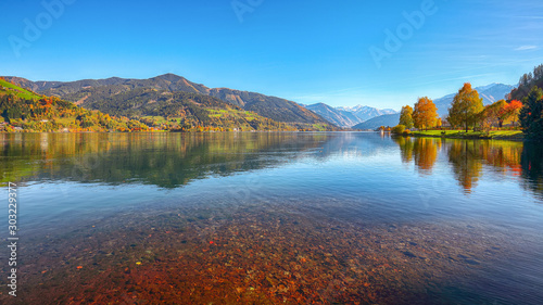 Spectacular autumn view of lake and trees in city park of Sell Am See © pilat666