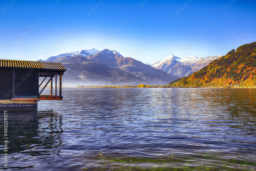 Spectacular autumn view of lake meadows trees and mountains in Sell Am See Spectacular autumn view of lake meadows trees and mountains in Sell Am See