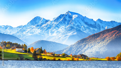 Splendid autumn panorama of Haidersee (Lago della Muta) lake with Ortler peak on backgroun photo