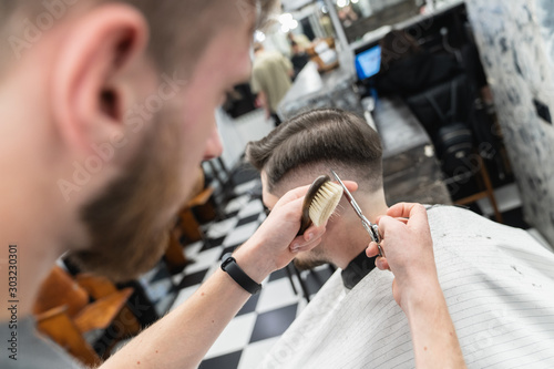 Haircut with beard and head scissors. Men's beauty salon. 