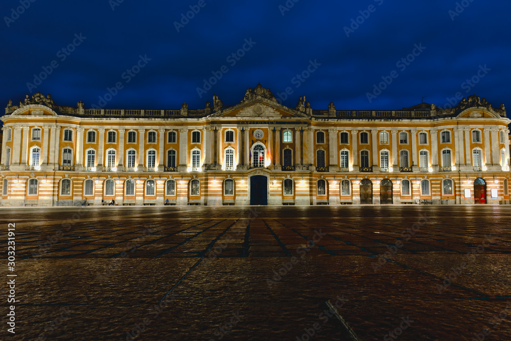 Place du Capitole at night with dark blue dramatic sky in Toulouse, France