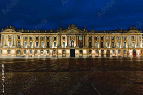 Place du Capitole at night with dark blue dramatic sky in Toulouse, France