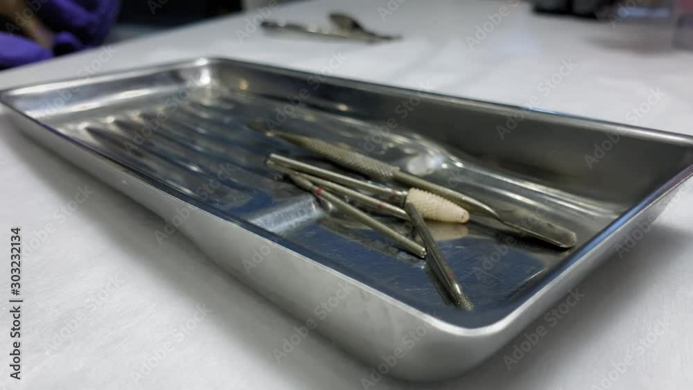 Close up. Master takes out tools for manicure from a paper bag. Stainless steel tool tray. Nail manicure process in a beauty salon. Manicure in the salon. Cuticle removal Close up. Master takes out tools for manicure from a paper bag. Stainless steel tool tray. Nail manicure process in a beauty salon. Manicure in the salon. Cuticle removal