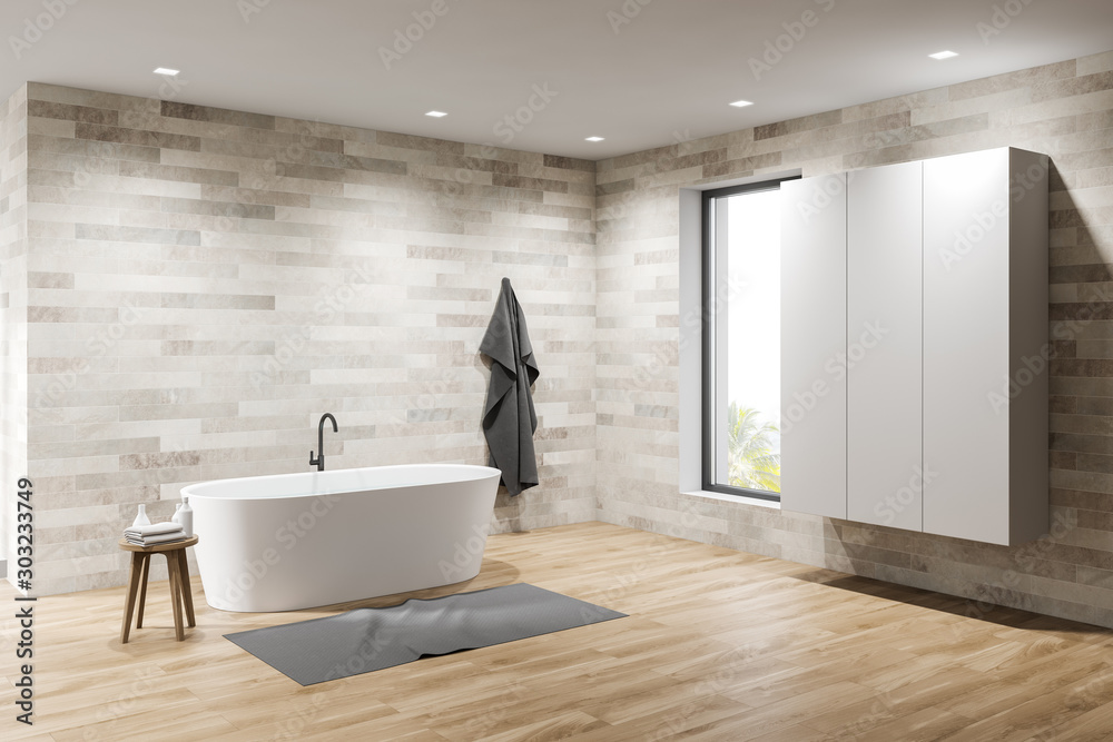 Light tile bathroom with tub and wardrobe Light tile bathroom with tub and wardrobe