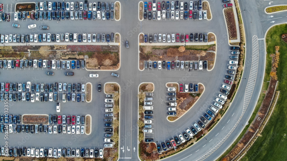 An aerial view of cars in a large parking lot during the holiday season