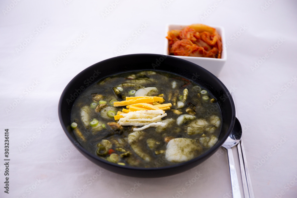 Korean Rice cake Seaweed Fulvescens Soup with oyster which is called Maesaeng-i Tteoggug and kimchi Korean Rice cake Seaweed Fulvescens Soup with oyster which is called Maesaeng-i Tteoggug and kimchi