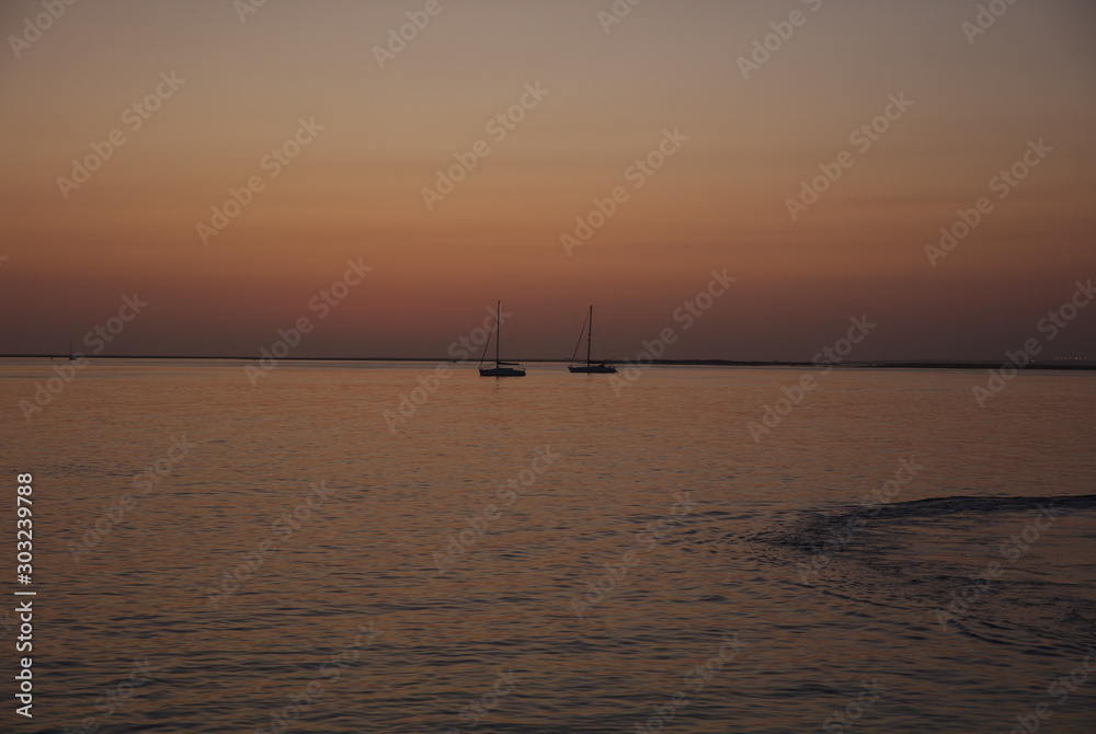 NB__8750 Sunset with anchored sailboats off Ilha Culatra Portugal