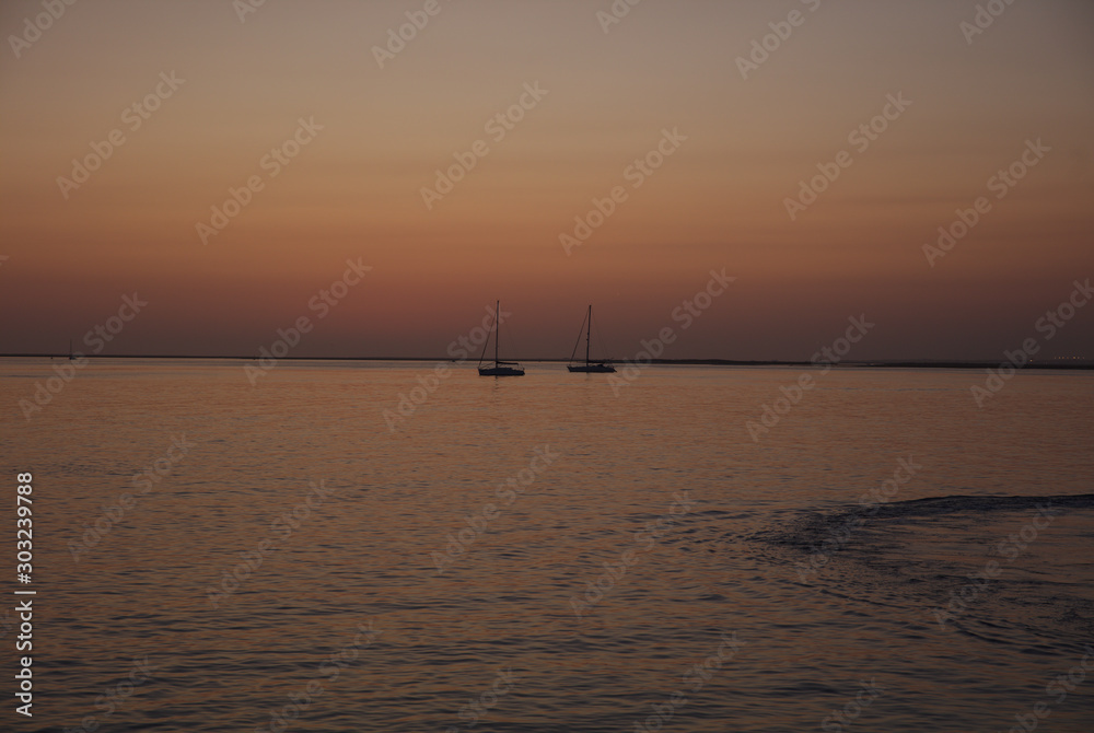 NB__8750 Sunset with anchored sailboats off Ilha Culatra Portugal NB__8750 Sunset with anchored sailboats off Ilha Culatra Portugal