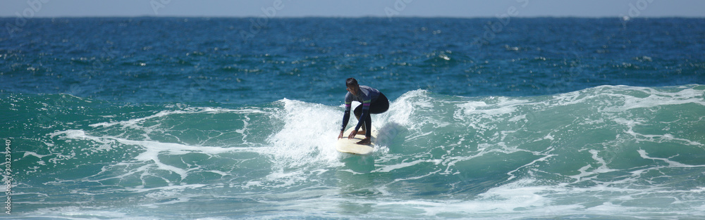 NB__9643 Young man surfing in Sagres
