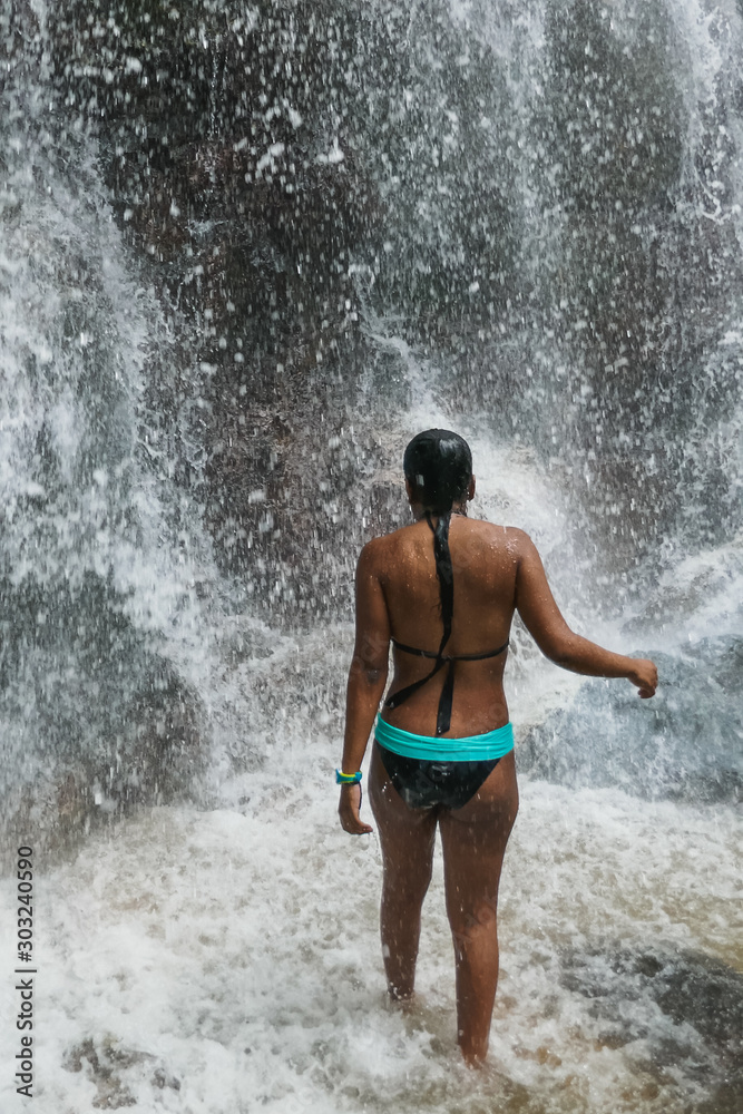 Woman under waterfall, on the bottom of rocks and river. Woman under waterfall, on the bottom of rocks and river.