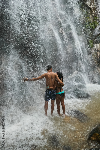 Boyfriends under waterfall, on the bottom of rocks and river. © Hector Pertuz
