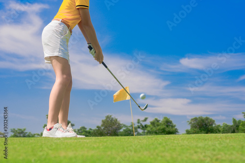 golf player concentrate in hit the golf ball away to the destination green for winning in score rate