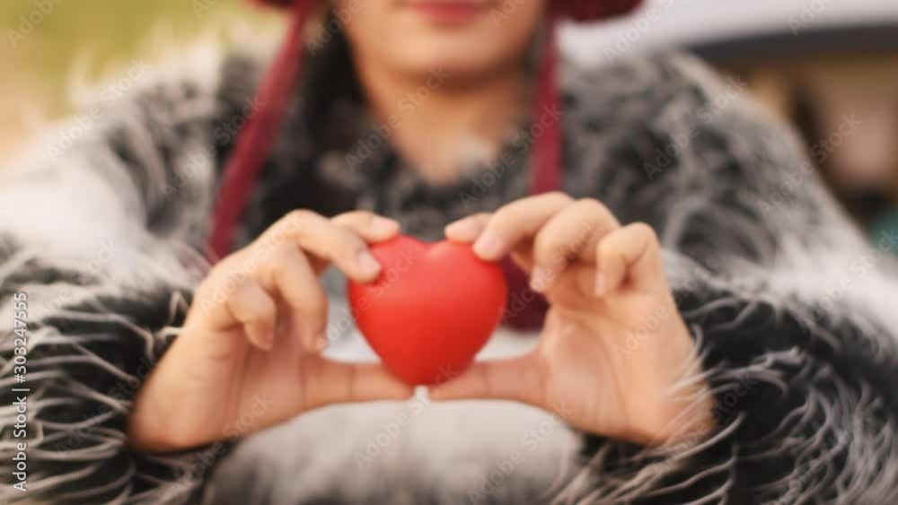 Close up showing red heart in woman hand ,winter Close up showing red heart in woman hand ,winter