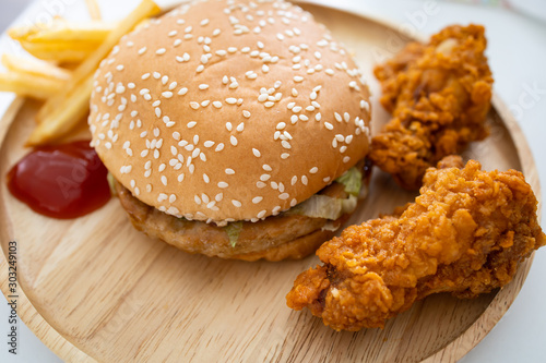 Fresh hamburger on a wooden plate photo