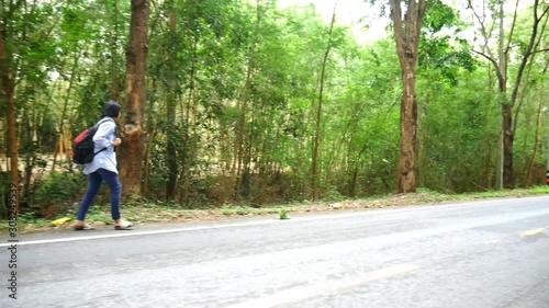Wallpaper Mural Asian teenage backpackers walking alone in the street in a country road in holiday time. Holiday and travel concept Torontodigital.ca