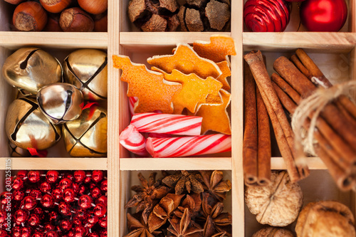 Wooden box with Christmas decorations, nuts and spices. Winter background