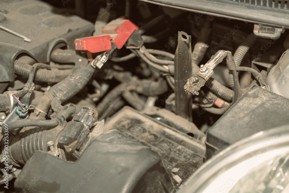 changing car battery in auto repair garage