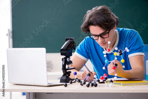 Tableau sur toile Young male student in the classroom
