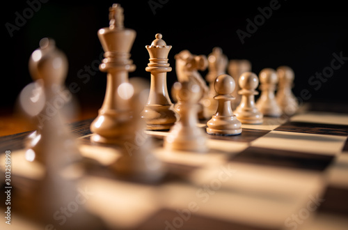 Close up of chess pieces on a chess board  representing strategy and tactics