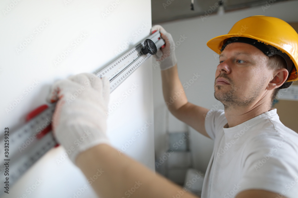 Worker making wall straight Worker making wall straight