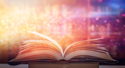 Abstract gold magic book on wooden background