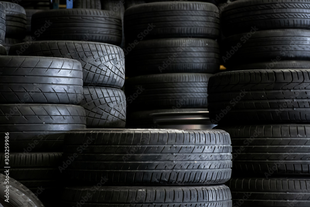 Old used car tires stacked in the repair garage. Old used car tires stacked in the repair garage.
