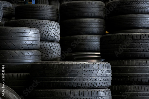 Old used car tires stacked in the repair garage.